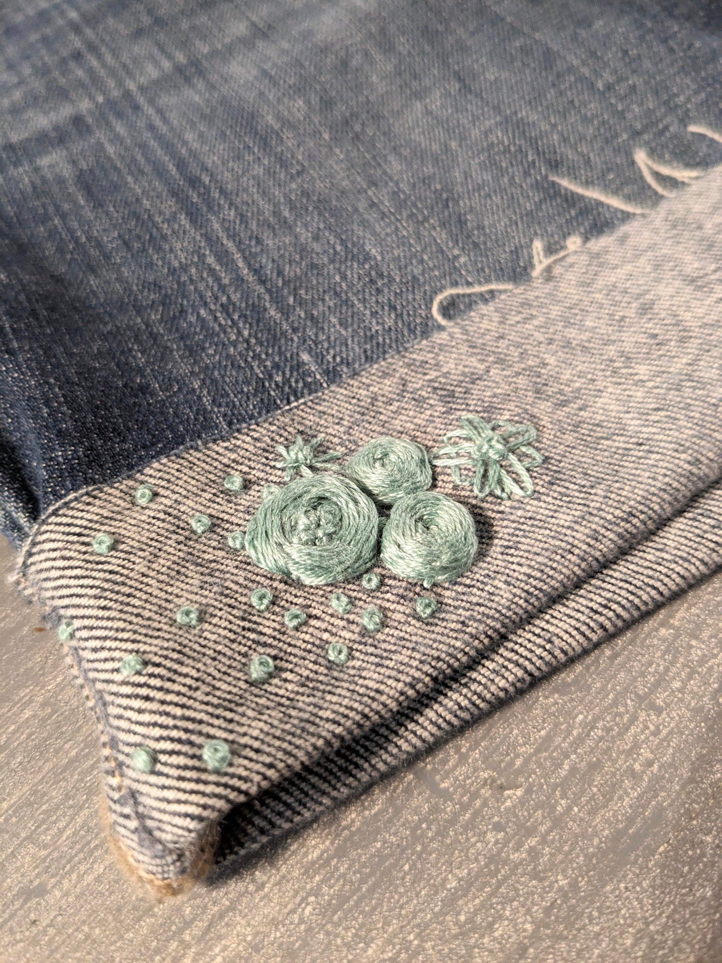 Hand-embroidered under-belly panel 4.5" cuffed hem denim shorts, Medium wash