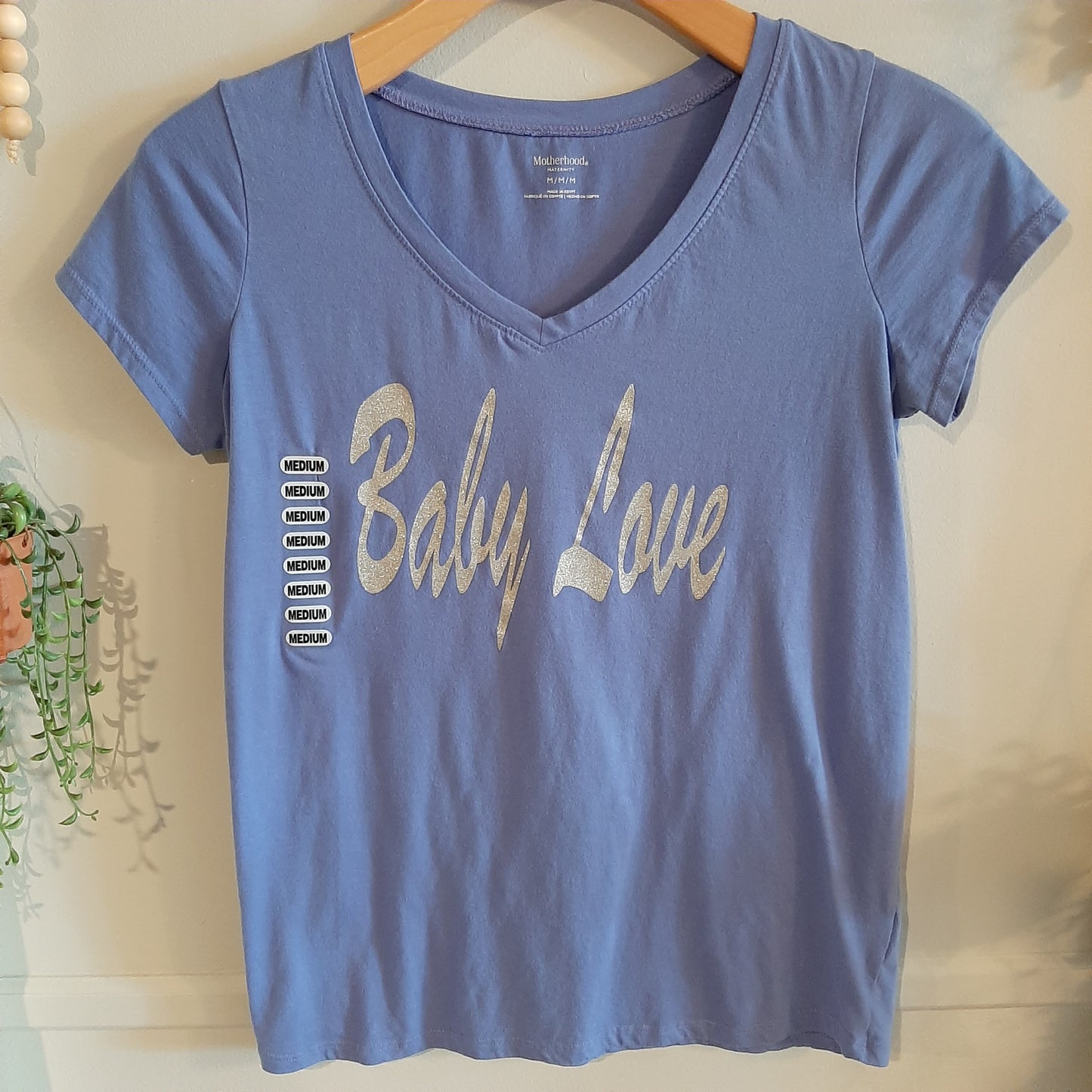 Maternity graphic tee with words 'Baby Love' on front.